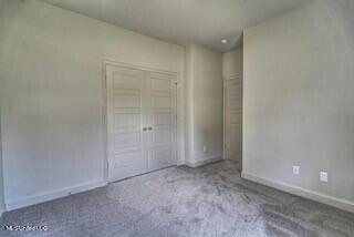 unfurnished bedroom featuring a closet and carpet