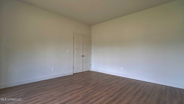 unfurnished room featuring dark hardwood / wood-style flooring