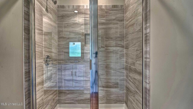 bathroom with a shower with door