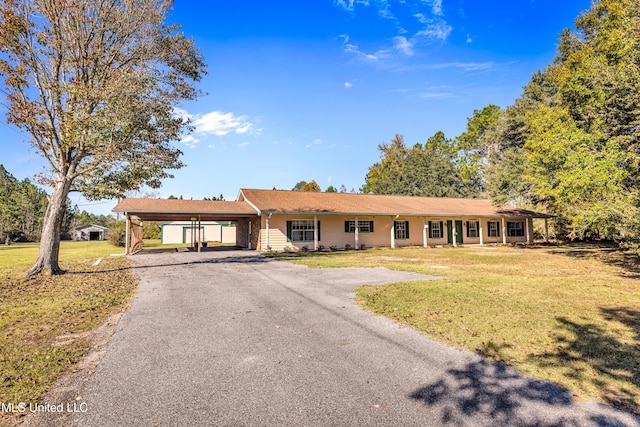 single story home with a front lawn and a carport