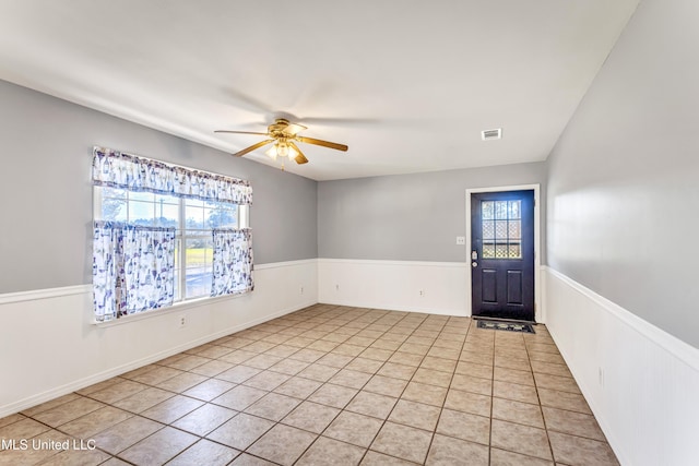 tiled entryway featuring ceiling fan