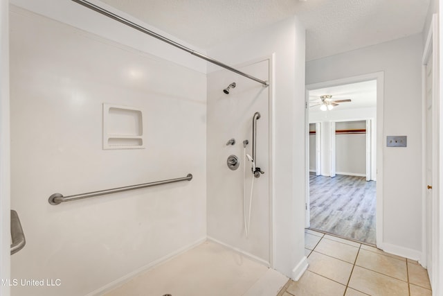 bathroom featuring walk in shower, a textured ceiling, tile patterned floors, and ceiling fan