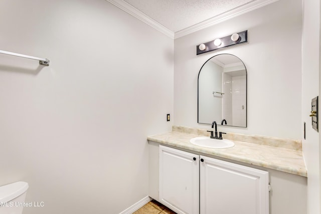 bathroom with tile patterned flooring, crown molding, a textured ceiling, toilet, and vanity