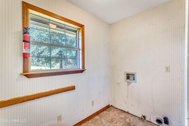 clothes washing area featuring washer hookup and a textured ceiling