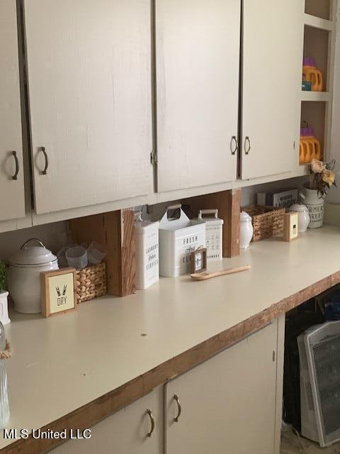 2145 Second St, Natchez, MS 39120 - detailed view of white cabinetry, light countertops, and open shelves