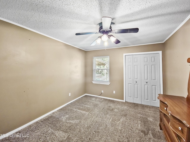 1334 Diller Rd, Ocean Springs, MS 39564 - unfurnished bedroom featuring a closet, ornamental molding, carpet flooring, baseboards, and a textured ceiling