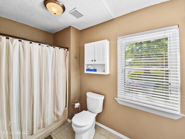 1334 Diller Rd, Ocean Springs, MS 39564 - full bath with toilet, tile patterned floors, a textured ceiling, and baseboards