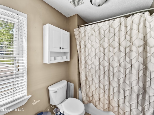 1334 Diller Rd, Ocean Springs, MS 39564 - full bathroom with shower / tub combo with curtain, toilet, and a textured ceiling