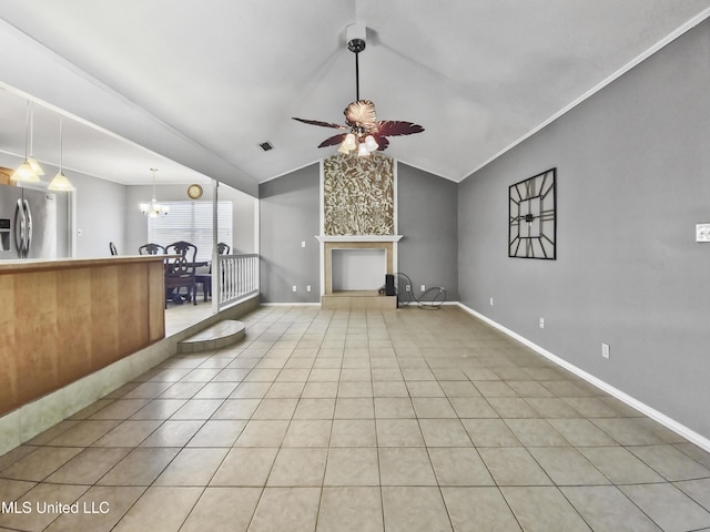 1334 Diller Rd, Ocean Springs, MS 39564 - unfurnished living room featuring a ceiling fan, light tile patterned flooring, a chandelier, vaulted ceiling, and baseboards