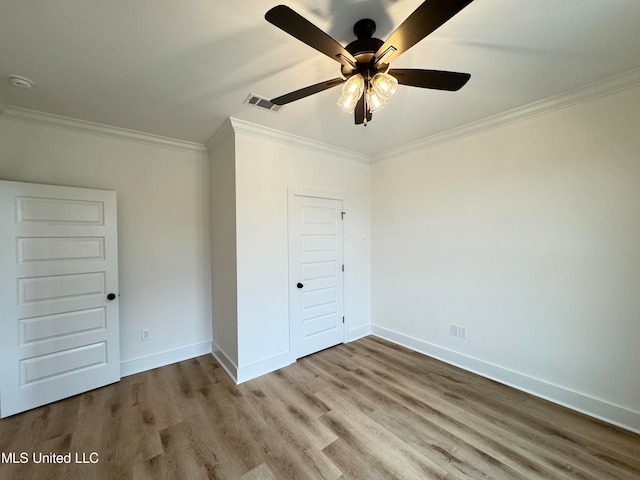 unfurnished bedroom with a closet, ceiling fan, crown molding, and light wood-type flooring