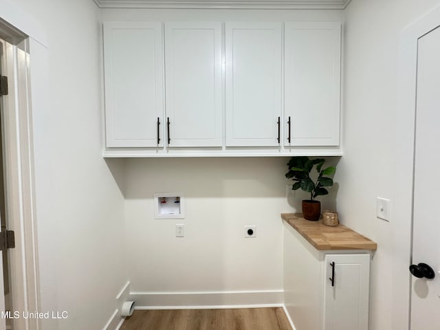 laundry area with cabinets, hookup for a washing machine, wood-type flooring, and electric dryer hookup