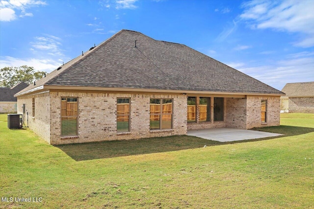 rear view of property featuring a yard, a patio, and central AC unit