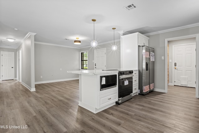 kitchen with black microwave, stainless steel fridge with ice dispenser, crown molding, wood finished floors, and baseboards