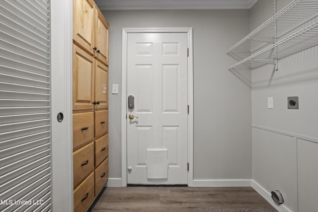 laundry area featuring hookup for an electric dryer, dark wood-type flooring, and baseboards