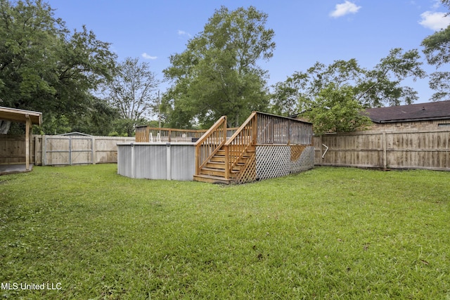 view of yard with a wooden deck and stairway