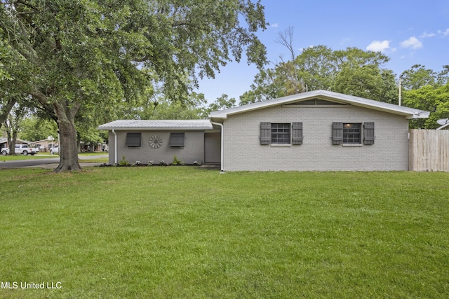 view of front of house featuring brick siding and metal roof