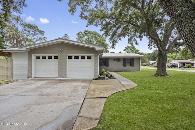 view of front of house featuring a front lawn, brick siding, and driveway