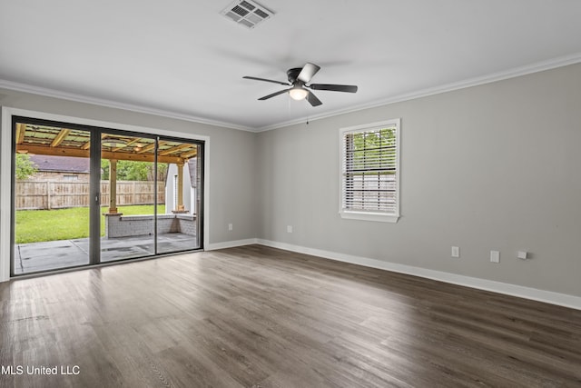spare room featuring ornamental molding, wood finished floors, ceiling fan, and baseboards