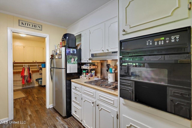 9414 Hillsboro Ludlow Rd, Lena, MS 39094 - kitchen featuring appliances with stainless steel finishes, under cabinet range hood, crown molding, dark wood finished floors, and white cabinets