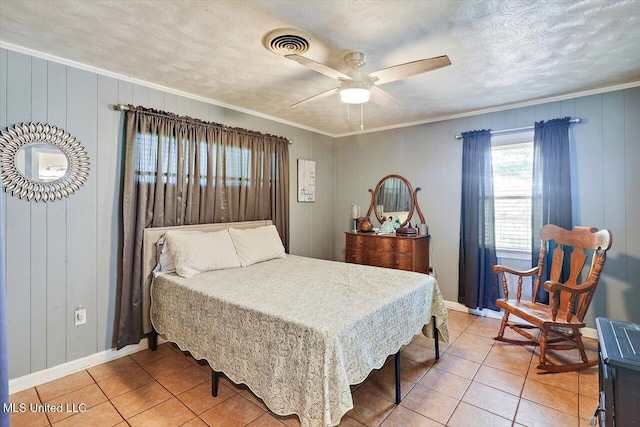 9414 Hillsboro Ludlow Rd, Lena, MS 39094 - bedroom with crown molding, light tile patterned floors, baseboards, a textured ceiling, and wooden walls