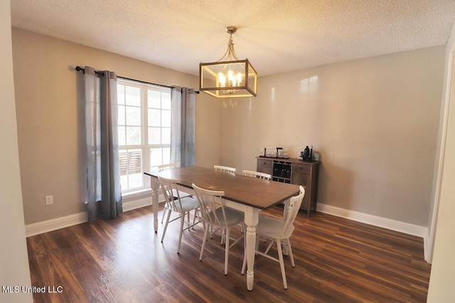 dining area featuring a notable chandelier, a textured ceiling, and dark hardwood / wood-style flooring