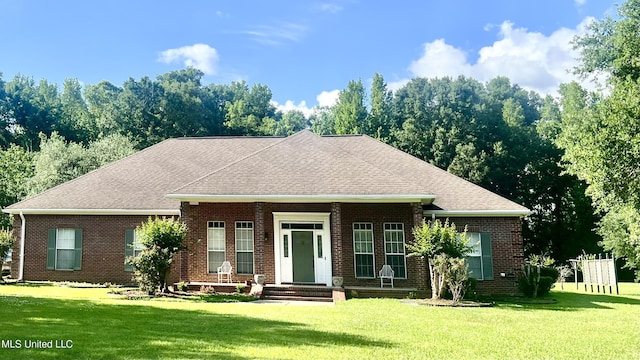 view of front of home featuring a front yard, brick siding, and roof with shingles