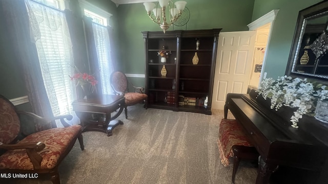 sitting room featuring a chandelier and carpet