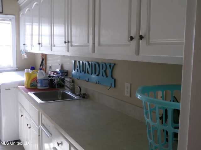 kitchen featuring a sink, white cabinetry, and light countertops