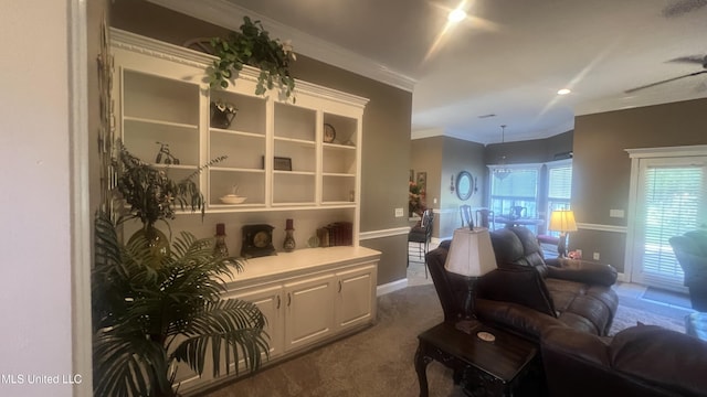 living room with dark colored carpet, ornamental molding, and baseboards