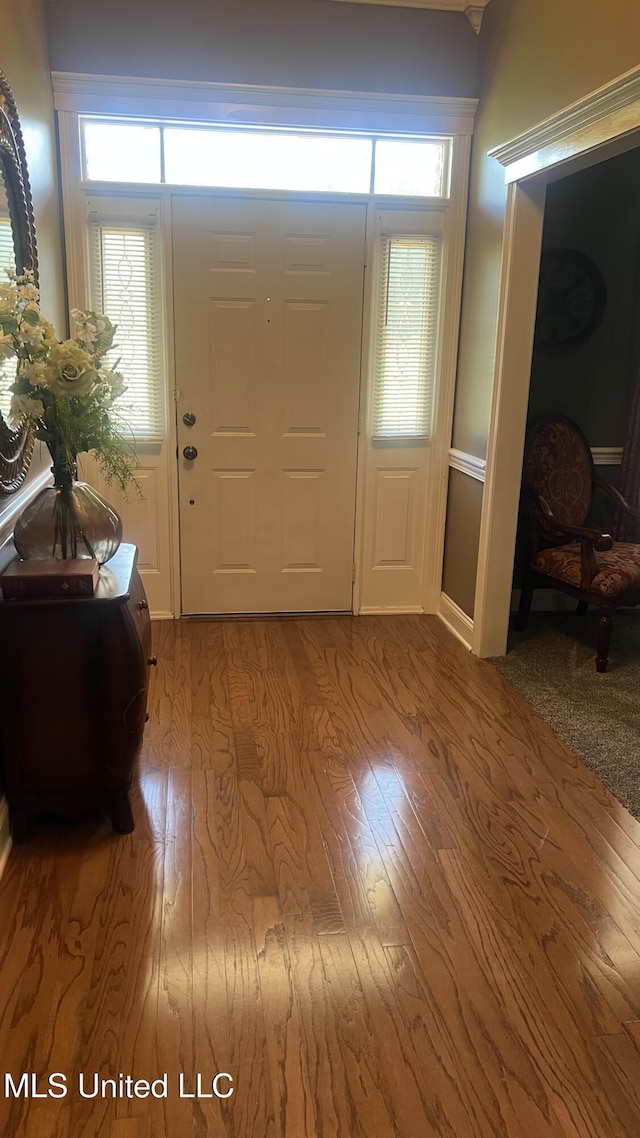 foyer with wood finished floors and baseboards
