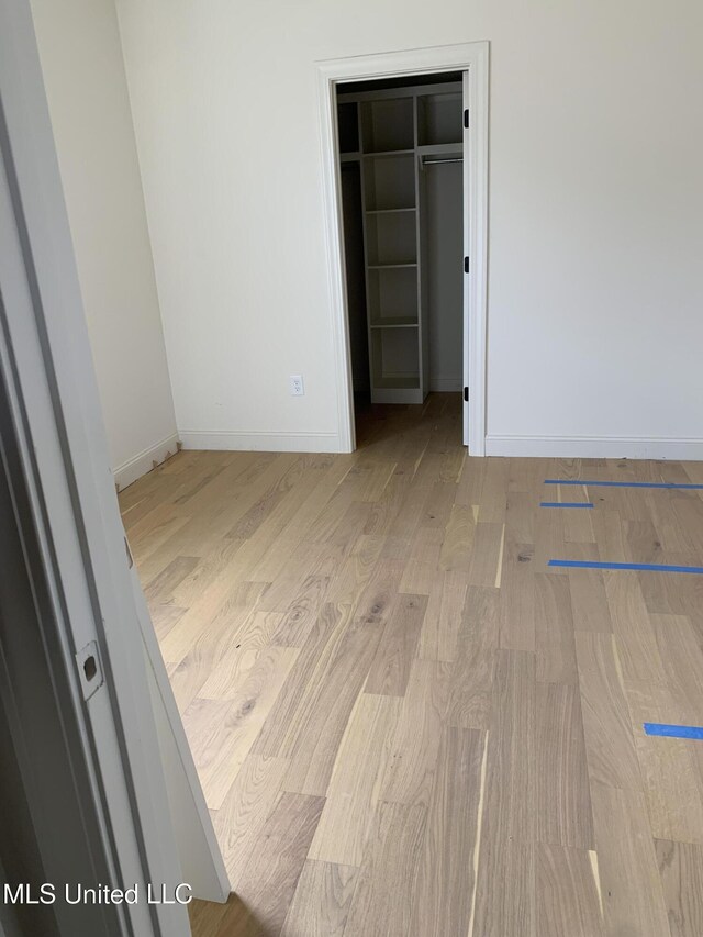 spare room featuring light wood-type flooring