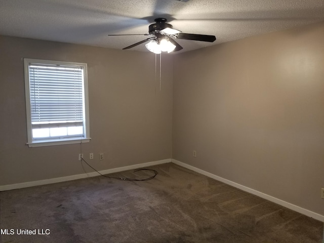 carpeted empty room featuring ceiling fan and a textured ceiling