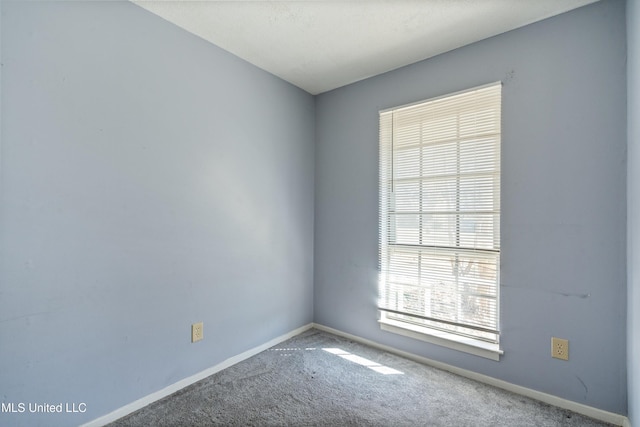 unfurnished room with carpet floors and plenty of natural light