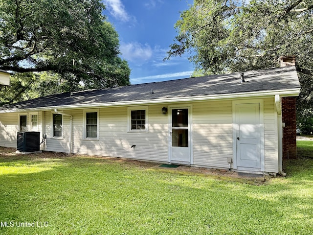 4425 Oak Ave, Moss Point, MS 39563 - rear view of house featuring a yard, a chimney, and a shingled roof