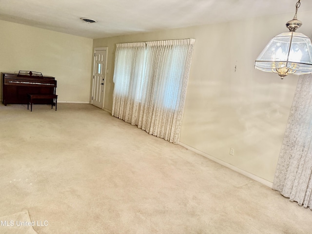 4425 Oak Ave, Moss Point, MS 39563 - carpeted empty room featuring a chandelier and baseboards