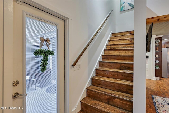 stairway featuring wood finished floors