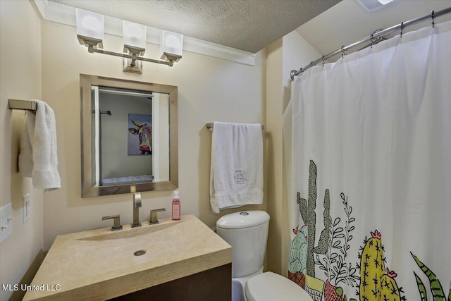 full bath with a textured ceiling, toilet, and vanity