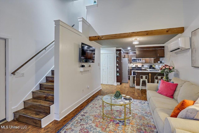 living room with baseboards, stairway, dark wood-type flooring, a wall mounted air conditioner, and a high ceiling