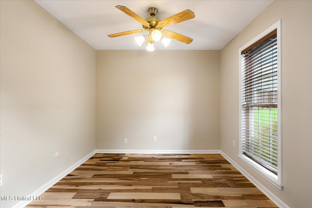 9015 Champlain Dr, Olive Branch, MS 38654 - spare room with baseboards, wood finished floors, and a ceiling fan