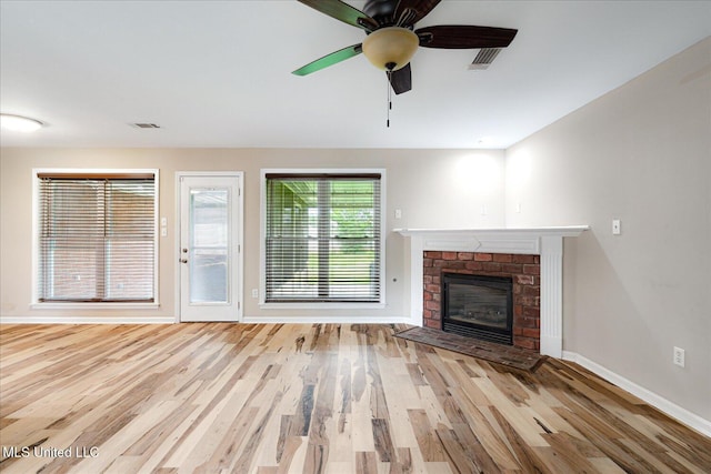 9015 Champlain Dr, Olive Branch, MS 38654 - unfurnished living room featuring baseboards, wood finished floors, a fireplace, and a ceiling fan