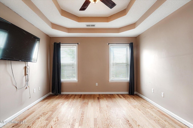 9015 Champlain Dr, Olive Branch, MS 38654 - spare room featuring a raised ceiling, wood finished floors, ceiling fan, and baseboards