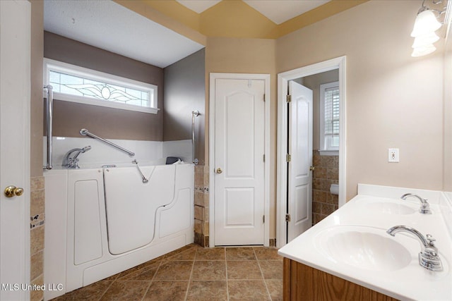 9015 Champlain Dr, Olive Branch, MS 38654 - full bath with a garden tub, double vanity, and washer / dryer