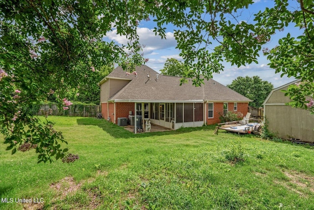 9015 Champlain Dr, Olive Branch, MS 38654 - rear view of property with a sunroom, brick siding, a shingled roof, and central AC unit