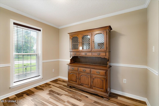 9015 Champlain Dr, Olive Branch, MS 38654 - spare room featuring light wood-style floors, crown molding, baseboards, and a textured ceiling