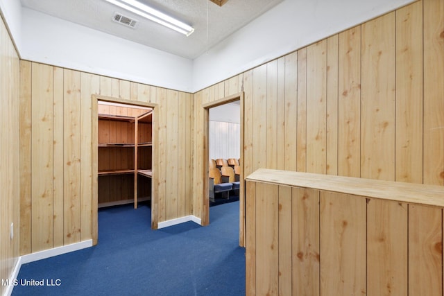 spacious closet featuring dark carpet