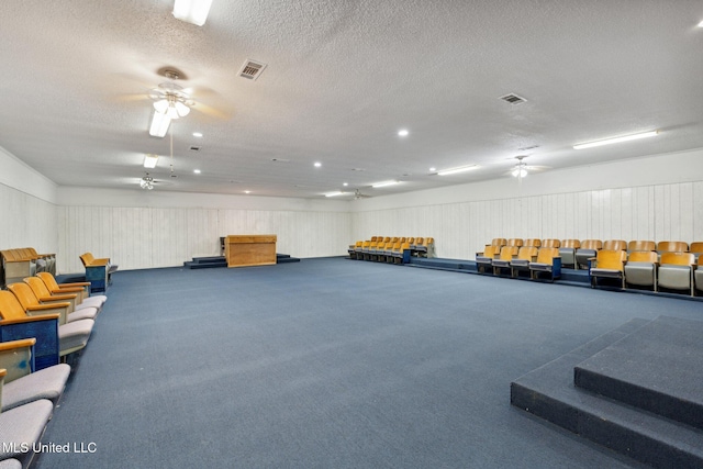 miscellaneous room with carpet and a textured ceiling