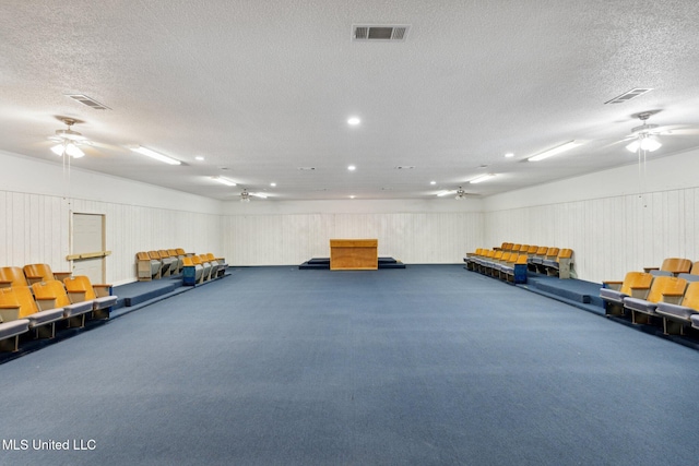 misc room with dark carpet and a textured ceiling