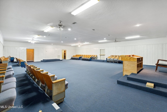 game room with a textured ceiling, carpet floors, ceiling fan, and billiards