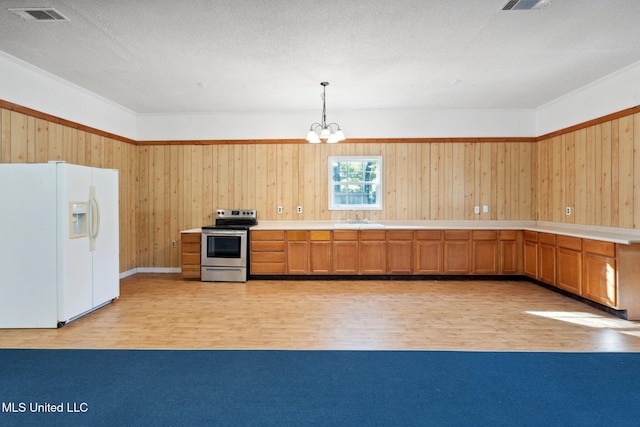 kitchen featuring stainless steel range with electric stovetop, sink, white refrigerator with ice dispenser, pendant lighting, and light hardwood / wood-style flooring