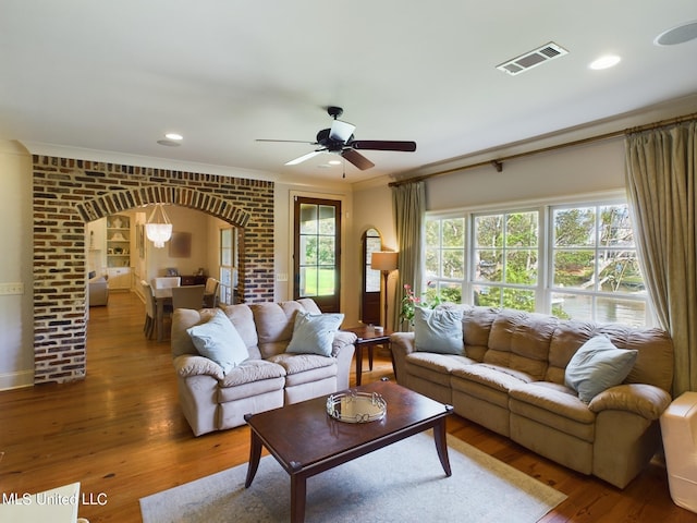 living room featuring crown molding, hardwood / wood-style floors, and ceiling fan